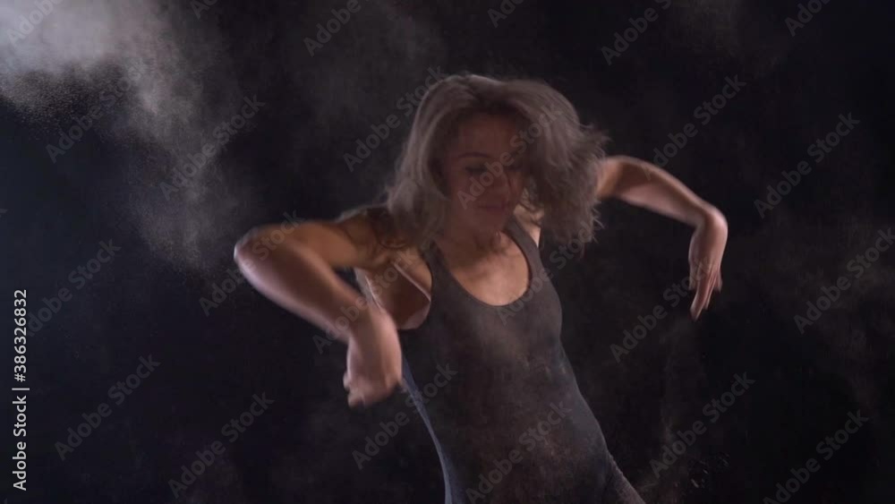 modern ballet dancer is performing dance in darkness, throwing dust or powder, emotion and passion dance performance modern ballet dancer is performing dance in darkness, throwing dust or powder, emotion and passion dance performance