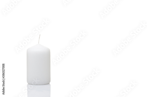 Billede på lærred White unlit candle on a white background, isolated, Christmas decoration