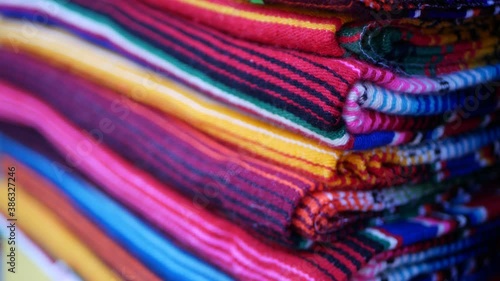 Colorful mexican wool serape blankets texture. Woven ornamental vivid textile with authentic latin american pattern. Striped multi colored fabric for poncho and sombrero. Hispanic indigenous style. photo