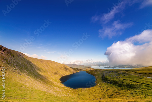 Panoramic view of Devils Punch Bowl lake on Mount Mangerton in the morning photo