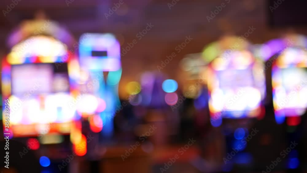 Defocused slot machines glow in casino on fabulous Las Vegas Strip, USA. Blurred gambling jackpot slots in hotel near Fremont street. Illuminated neon fruit machine for risk money playing and betting. Defocused slot machines glow in casino on fabulous Las Vegas Strip, USA. Blurred gambling jackpot slots in hotel near Fremont street. Illuminated neon fruit machine for risk money playing and betting.