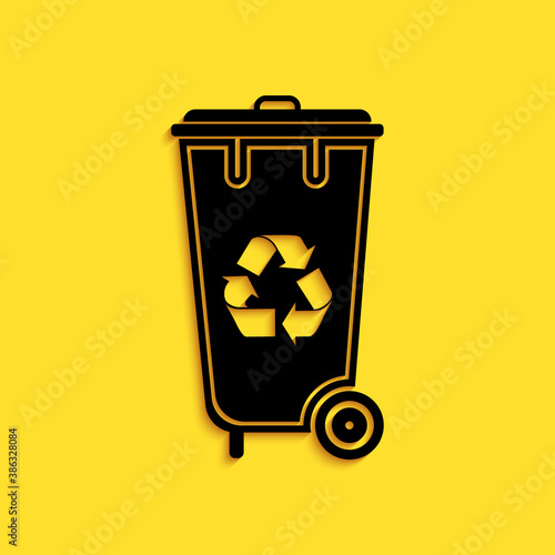 Black Recycle bin with recycle symbol icon isolated on yellow background. Trash can icon. Garbage bin sign. Recycle basket icon. Long shadow style. Vector.