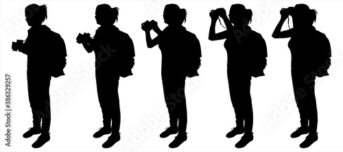 Birdwatcher. Tourists with backpacks on the hike. Girls with binoculars in their hands. Ornithologist. Hiking. Side view, profile. Five black female silhouettes are isolated on a white background.