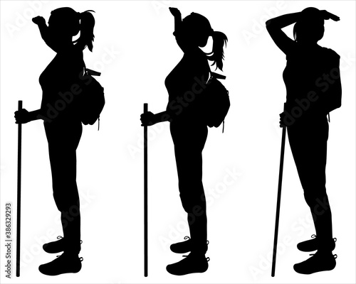 Tourist with a backpack behind back and a walking stick in hands. Woman is watching around. Girl raised her hand up and peers forward, up, back. Black silhouettes are isolated on a white background.
