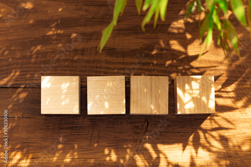 Groupped wooden square blocks on dark wooden table