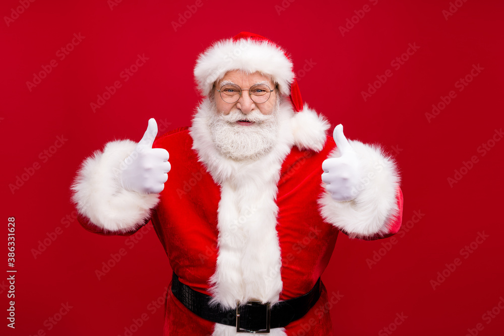Portrait of his he nice handsome attractive cheerful content overweight glad bearded Santa father showing two double thumbup advert ad isolated bright vivid shine vibrant red color background