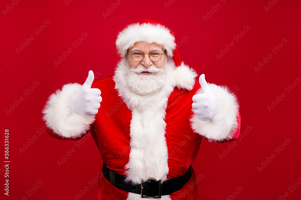 Portrait of his he nice handsome attractive cheerful content overweight glad bearded Santa father showing two double thumbup advert ad isolated bright vivid shine vibrant red color background Portrait of his he nice handsome attractive cheerful content overweight glad bearded Santa father showing two double thumbup advert ad isolated bright vivid shine vibrant red color background