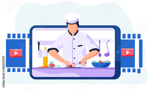 Professional chef slices bell pepper on a cutting board for the salad. Video recording of a blog via the Internet. A man on a blue tablet screen teaches to cook different meals. Online cooking