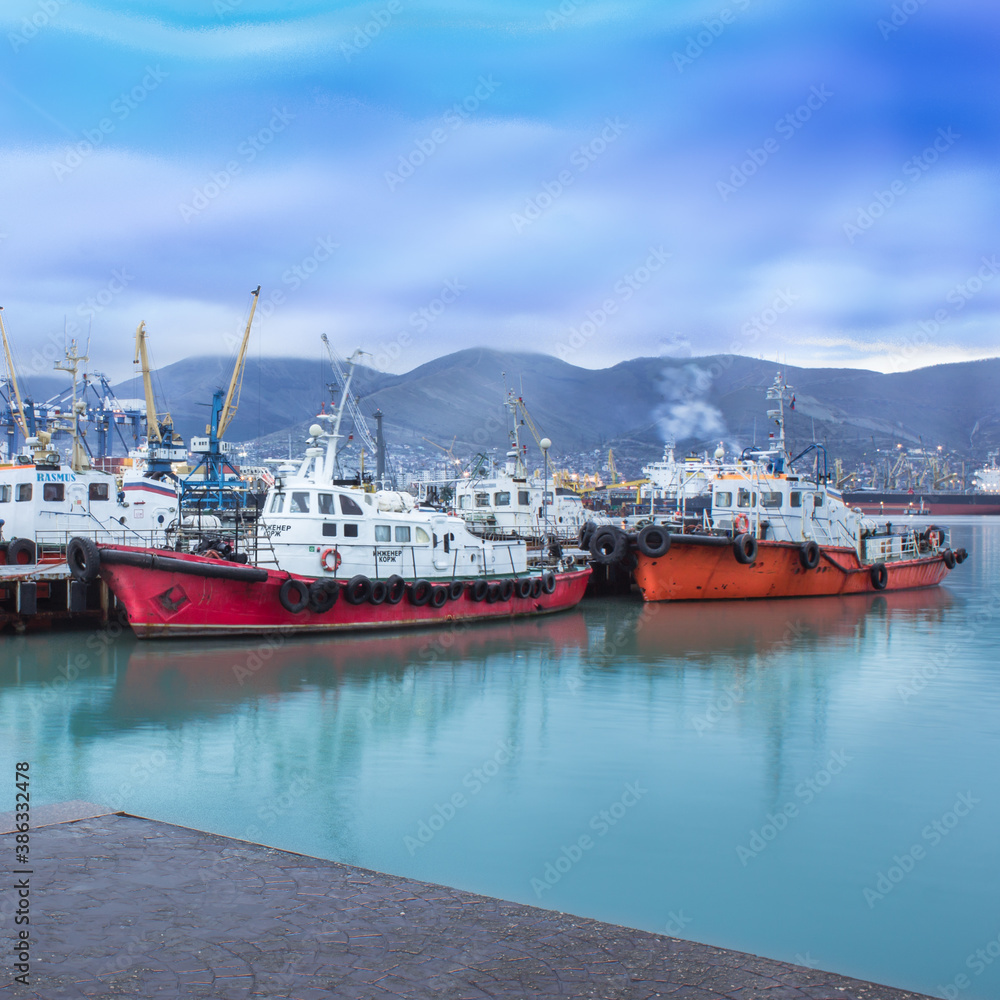 Russia, Novorossiysk - 03/26/2017: Seaport with boats on the Black Sea on a cloudy day.