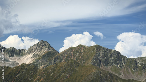 The high mountains of the Austrian Alps in Kuhtai during summer season. The sunshine illuminates the beautiful landscape.