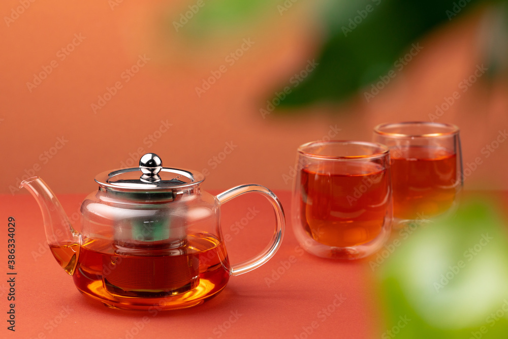 Glass teapot and two glass cups with tea Glass teapot and two glass cups with tea