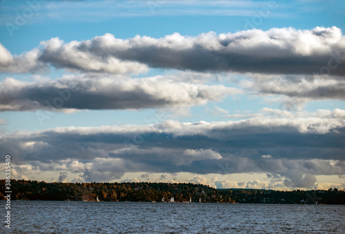 clouds and sailinboats over the sea, nacka, stockhom, sverige, sweden photo