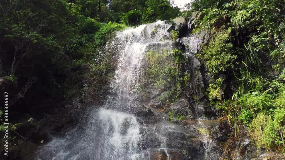 Waterfall with fast current surrounded by lush green nature. Waterfall with fast current surrounded by lush green nature.