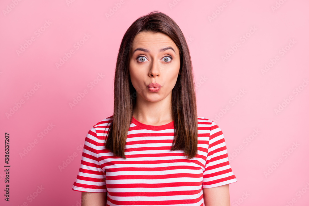 Photo of curious brown hair nice girl wear striped red white cloth isolated over pastel pink color background Photo of curious brown hair nice girl wear striped red white cloth isolated over pastel pink color background