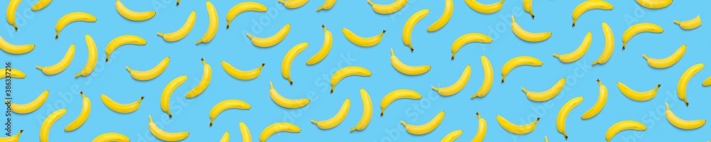 Bananas creative background. pop art bananas background. Tropical abstract background with banana. Colorful fruit yellow banana