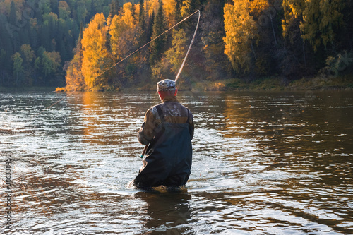 Spinning fishing on the river at sunset. Ural area
 photo