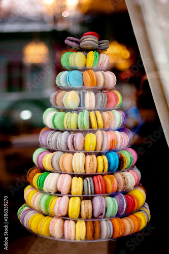 Pyramid of diverse colorful macarons in a shop-window.