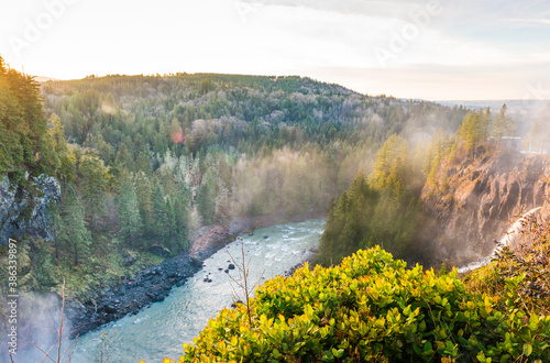 snowqualmie fall at sunset with a lot of fog. photo