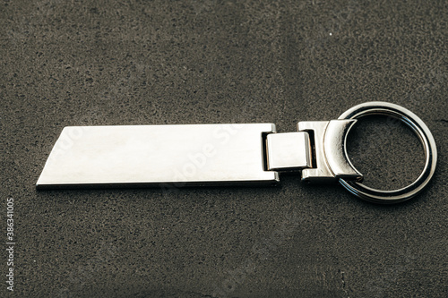 Metal key pendant on dark concrete background