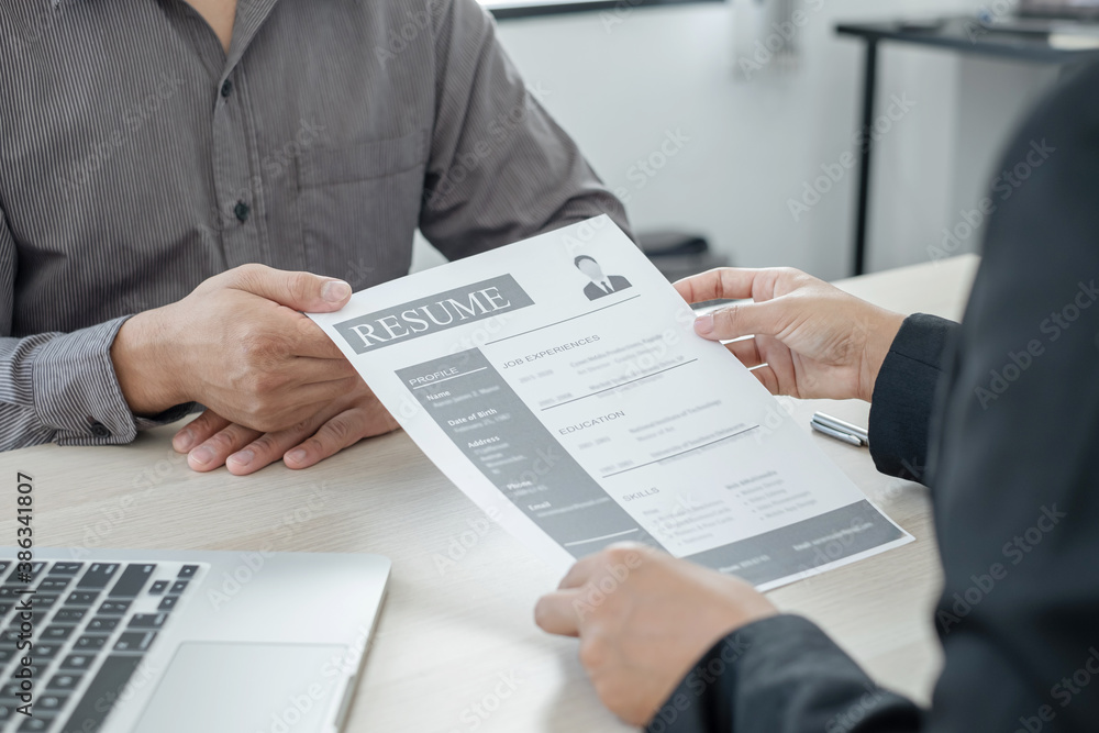 Business people hold a resume and talk to job applicants for job interviews about careers and Her personal history in the company. Recruitment concepts Business people hold a resume and talk to job applicants for job interviews about careers and Her personal history in the company. Recruitment concepts