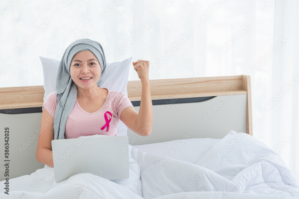women wearing pink ribbons fight with computer on bed women wearing pink ribbons fight with computer on bed