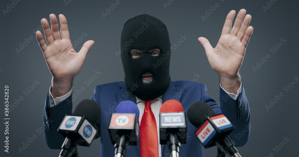 Criminal politician wearing a balaclava and talking to the media Criminal politician wearing a balaclava and talking to the media