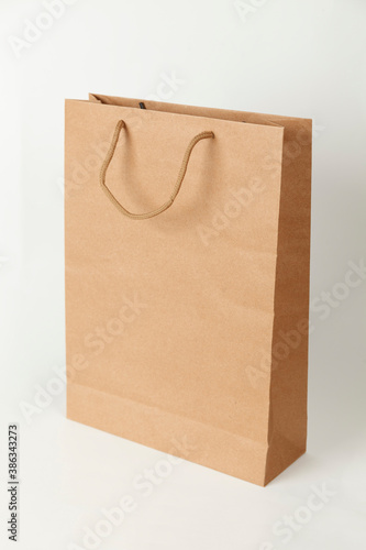 Brown ecological paper bag on white background. Store packaging.
