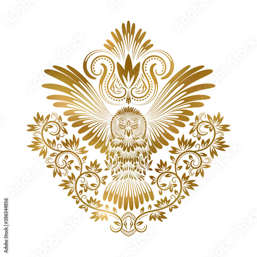 Patterned golden owl with outstretched wings. Ethnic coat of arms with owl in tribal totem style.