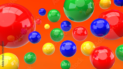 Colorful bouncing balls on orange backdrop