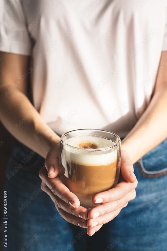 Woman holding a cup of coffee Woman holding a cup of coffee