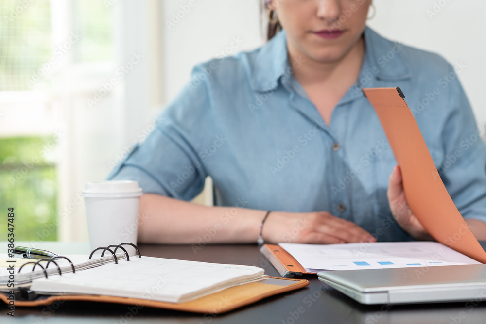 Businesswoman opening folder Businesswoman opening folder
