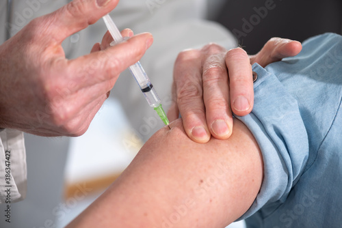 Doctor giving vaccin injection to patient