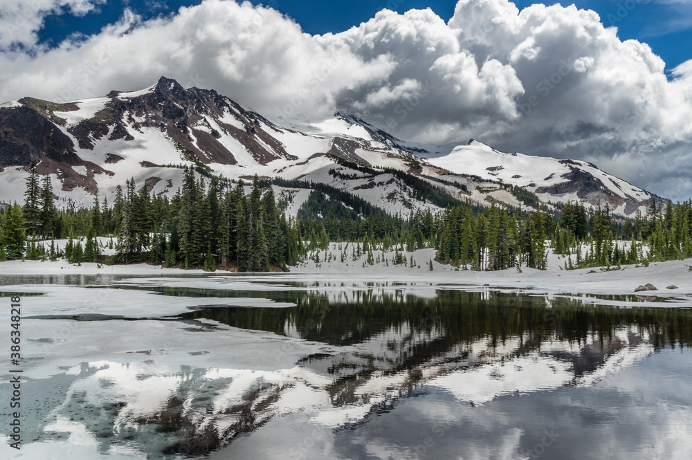 Clouds pass over Mt Jefferson as Scout Lake thaws in the spring.