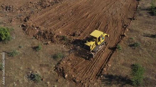 Earthworks Dozer (Bulldozer) Excavator in mountainous terrain, land correction and field clearing