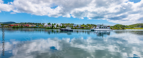 Green Bay of St John's, Antigua and Barbuda. Panoramic view of the harbour bay with boats and reflection of the clouds in the water. photo