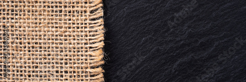 Part of sackcloth with black background. Woven burlap panorama