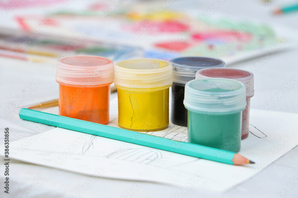 A group of jars with multicolored gouache.Pencil on the front.Concepft of the child art and painting. A group of jars with multicolored gouache.Pencil on the front.Concepft of the child art and painting.
