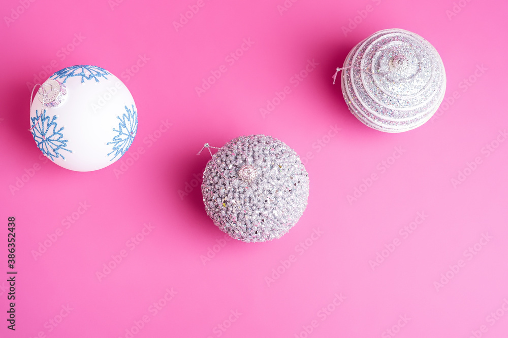 Christmas New Year composition. Gifts, silver and white ball decorations on pink background. Winter holidays concept. Top view Christmas New Year composition. Gifts, silver and white ball decorations on pink background. Winter holidays concept. Top view