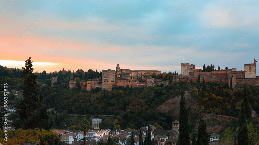 Panoramic view of Alhambra in Granada, Spain. Alhambra fortress and Albaicin quarter at twilight sky scene-Autumn mood