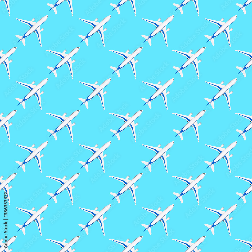 Seamless pattern with white airplane on blue background. Repetitive travel print for paper, fabric or wallpaper. Toy plane from above. Travel and advantures concept, flat lay style