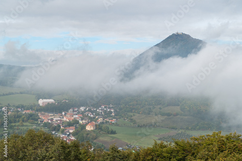 milesovka mountain seen from ostry above morning fog