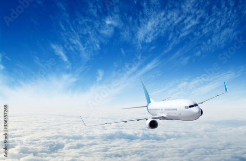 Landscape with airplane is flying in the blue sky and white clouds.