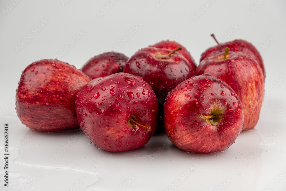 Pile of red apple with clear water drop on shell surface texture pattern isolated, white background