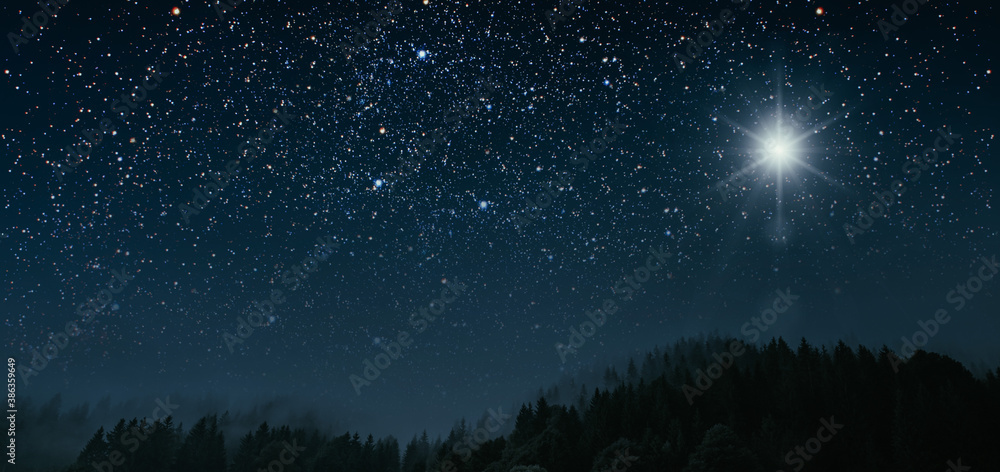 Fototapeta premium The star shines over the manger of christmas of Jesus Christ