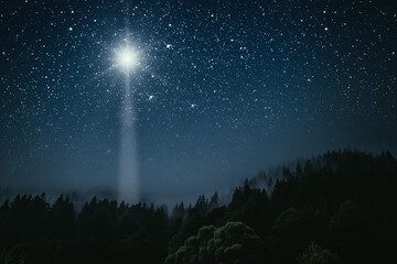 The star shines over the manger of christmas of Jesus Christ.
