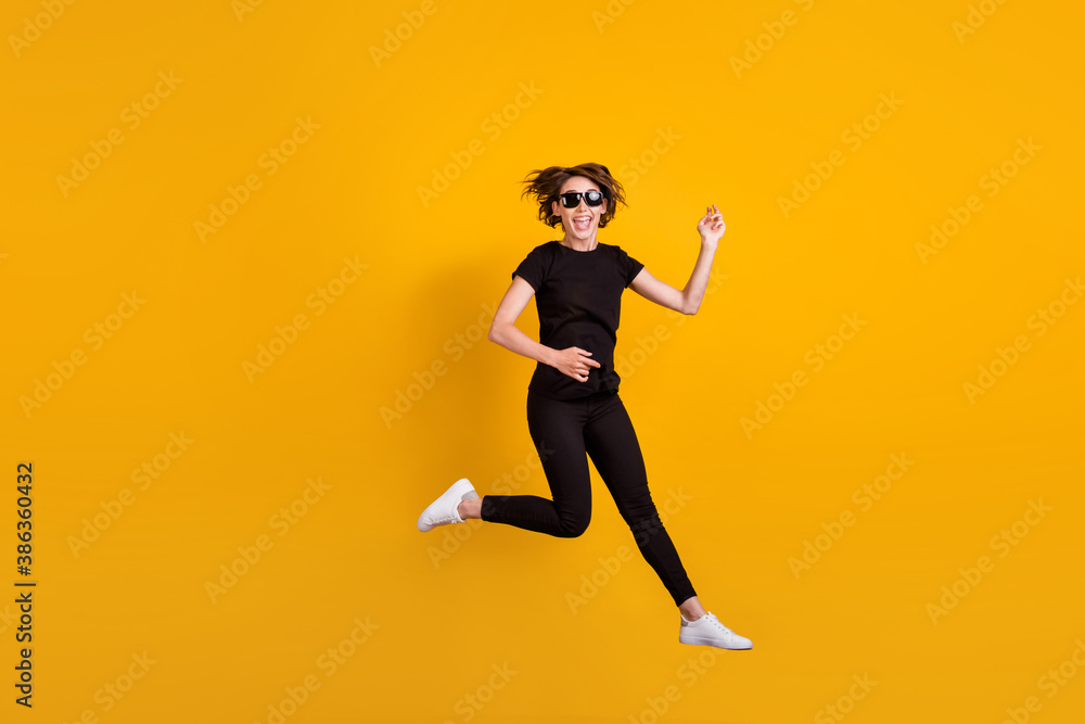 Full length body size view of attractive ecstatic carefree cheerful girl jumping having fun fooling isolated bright yellow color background