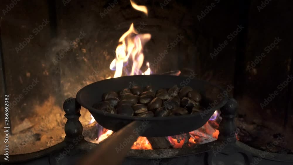 Roasting chestnuts in a frying pan on the fireplace. Stock video of