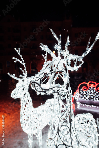 Christmas decorations on the street. White Christmas deer.