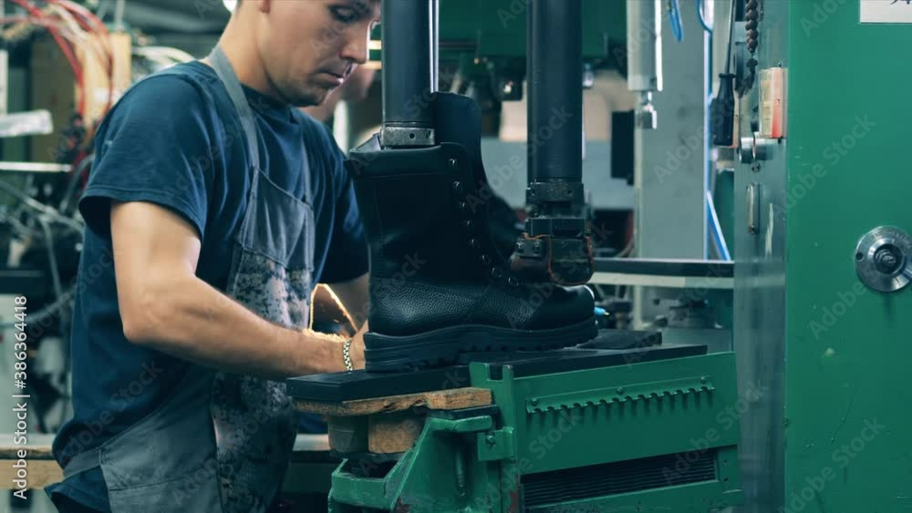 Shoemaker marking a shoe sole line. Shoemaking industry concept. Shoemaker marking a shoe sole line. Shoemaking industry concept.