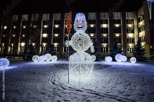 Beautiful festive luminous snowmen from electric garlands photo